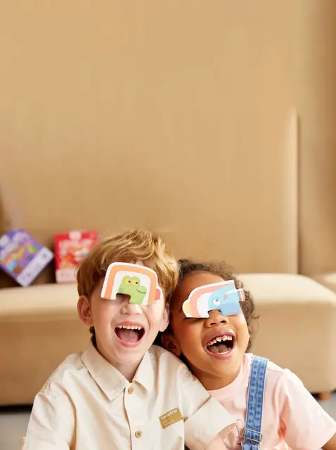 Two children laughing with mideer kaleidoscope glasses
