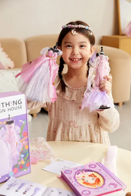 A girl showing a mideer dress-up design kit