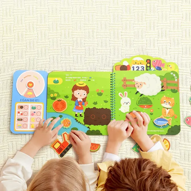 Hands working through a mideer activity book