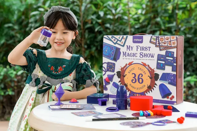 A child performing tricks from the mideer magic show set