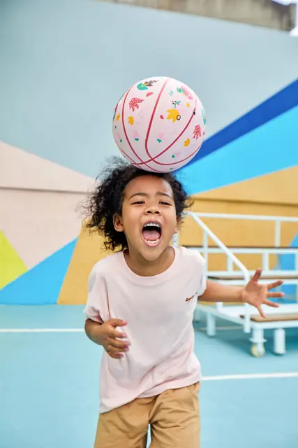 A child playing with a mideer soft ball