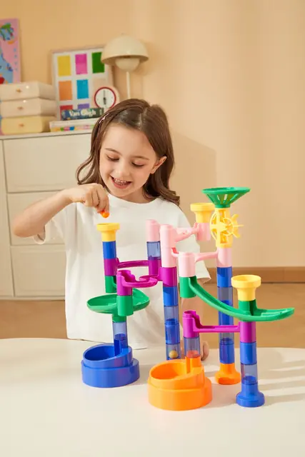 A girl building a mideer marble run