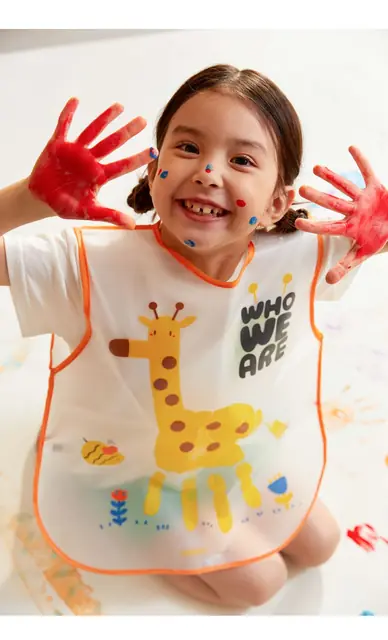 A child showing painted hands with mideer finger paints
