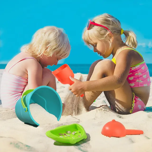 Children playing with mideer beach toys in the sand