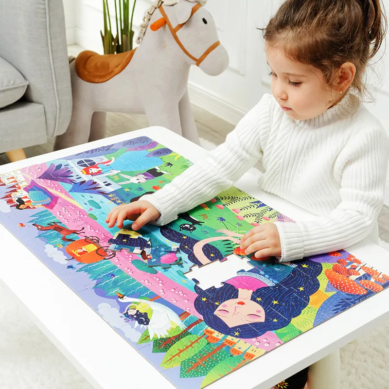 A girl completing a large mideer floor puzzle